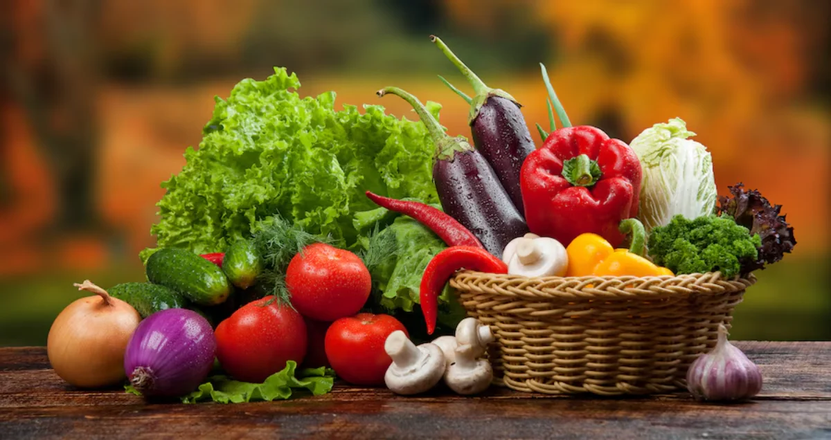 A variety of fresh vegetables including lettuce, cucumbers, tomatoes, onions, eggplants, red bell peppers, chilli peppers