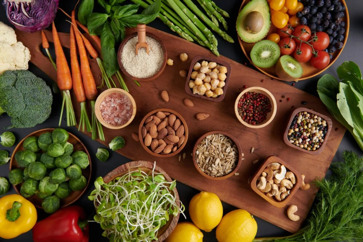 An array of fresh and healthy foods including carrots, almonds, lemons, and various other fruits and vegetables