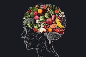 Silhouette of a human head filled with various colorful fruits and vegetables on a dark background, symbolizing healthy eating for brain health.